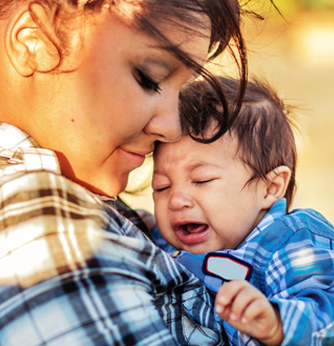 Mom comforting crying baby