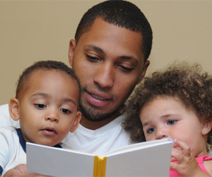 Father reading to children